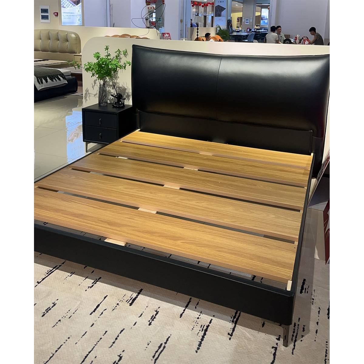 Side angle view of the bed showing the headboard and slat structure