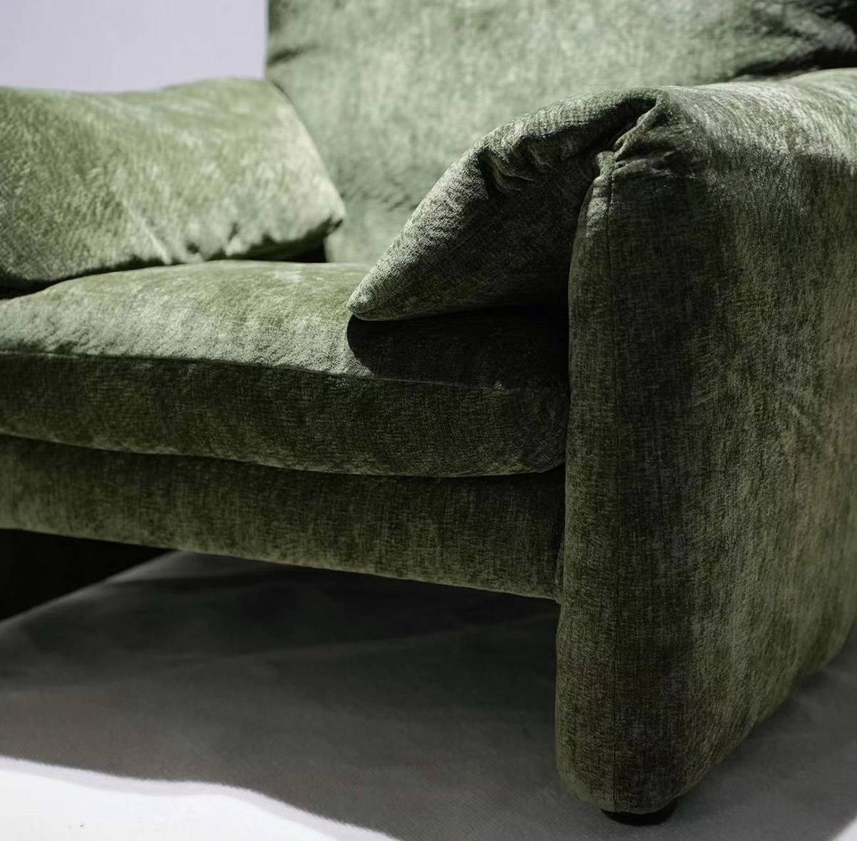 Close-up detail of the green velvet fabric and armrest