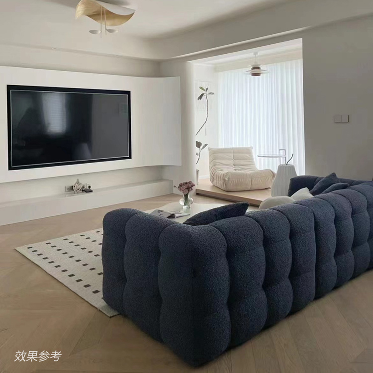Rear view of blue tufted sofa in a living room