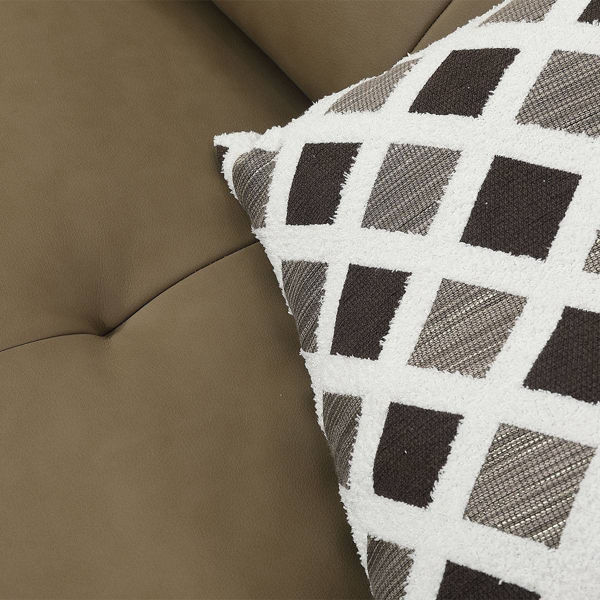 Close-up detail of the sofa fabric texture and a patterned throw pillow