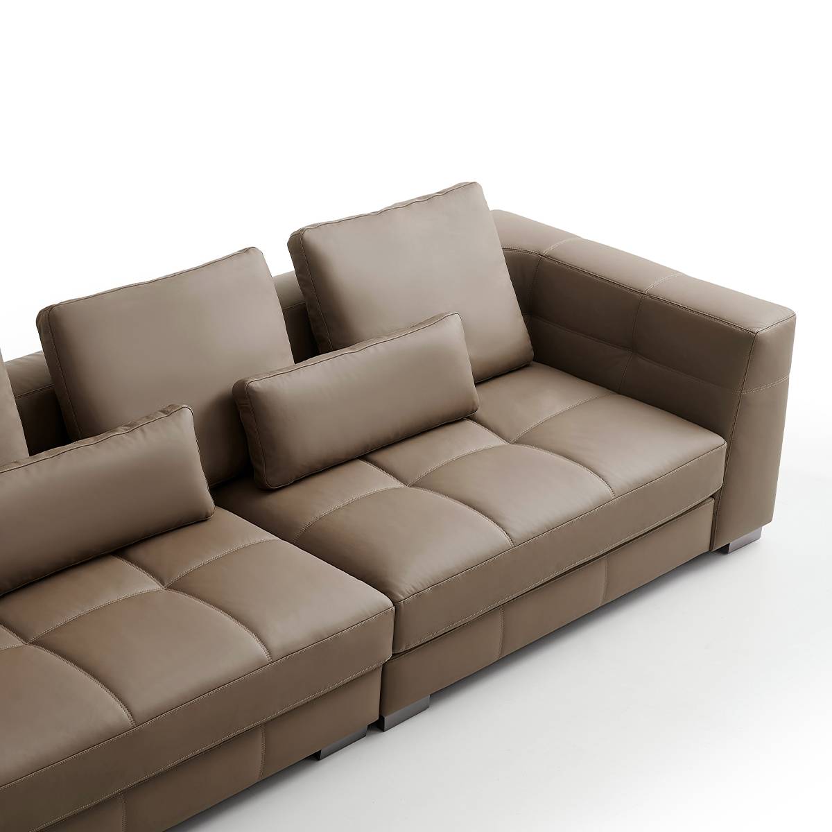 Detail shot of the leather texture and stitching on the sofa seat