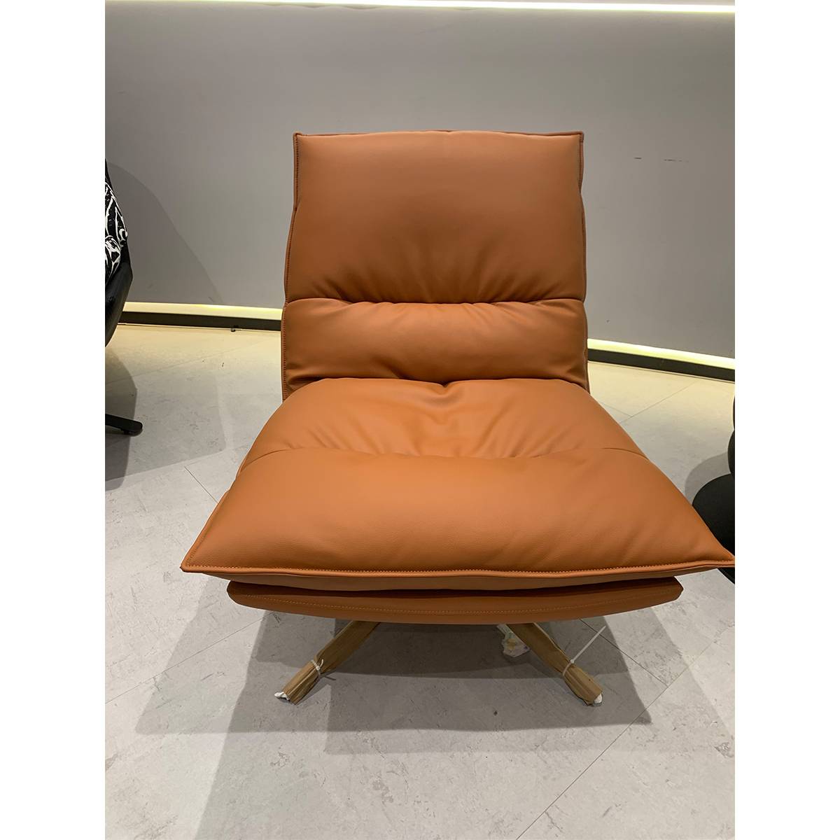 Front view of a tan leather swivel lounge chair