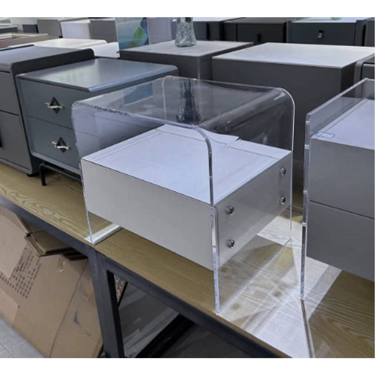 Side view of the acrylic bedside table showing the drawer mechanism