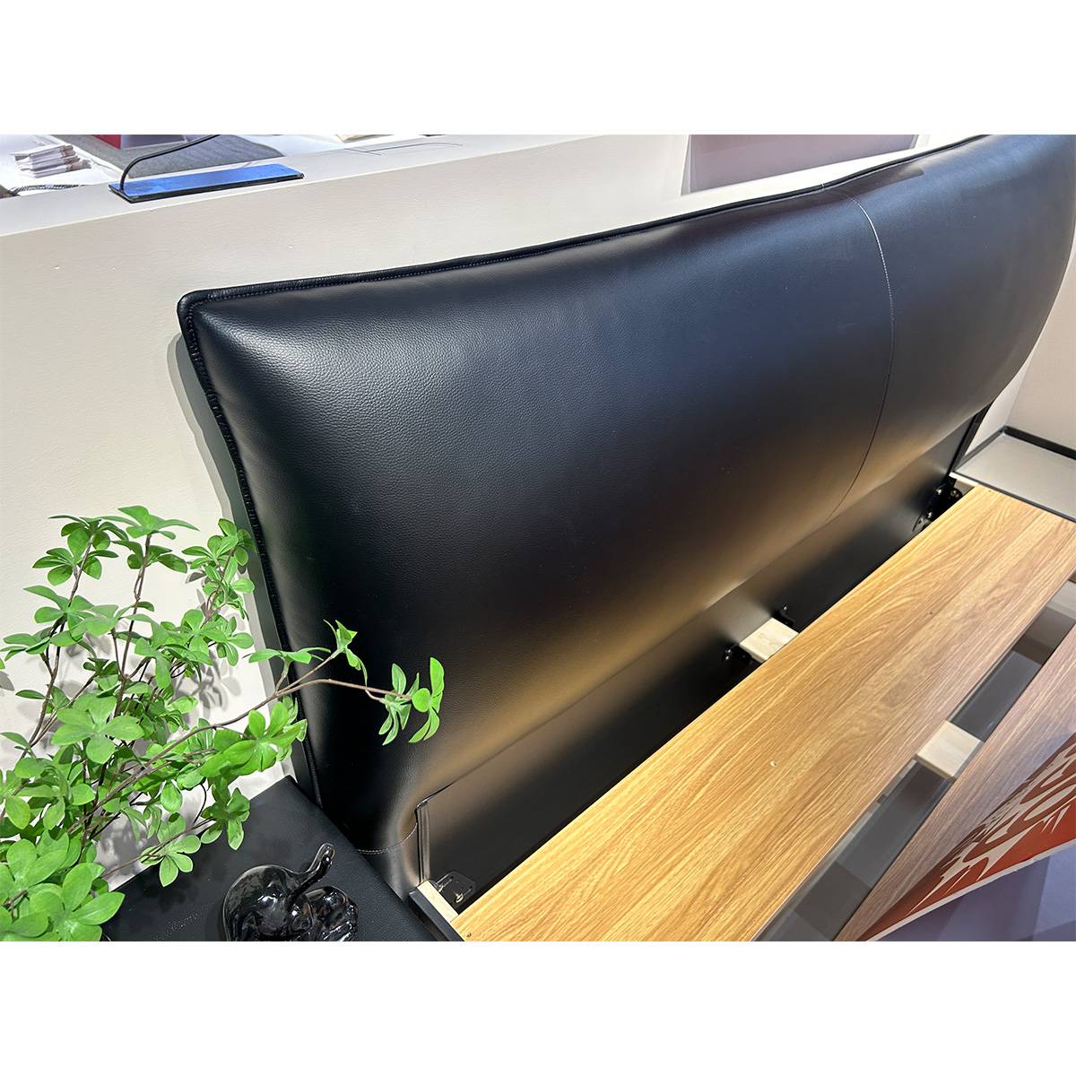 Close-up detail of the black eco-leather headboard texture