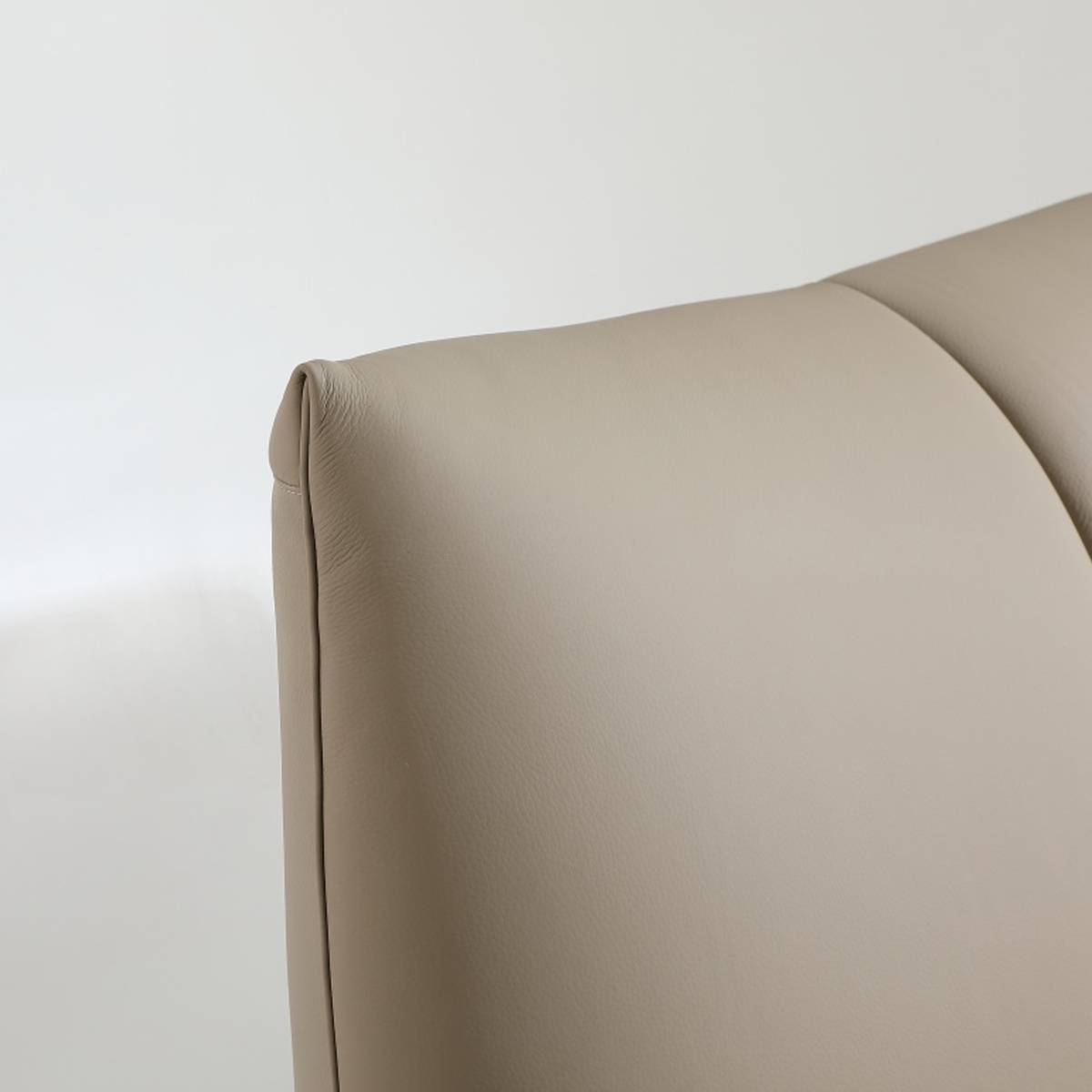 Close-up detail of the leather upholstery and stitching on the headboard