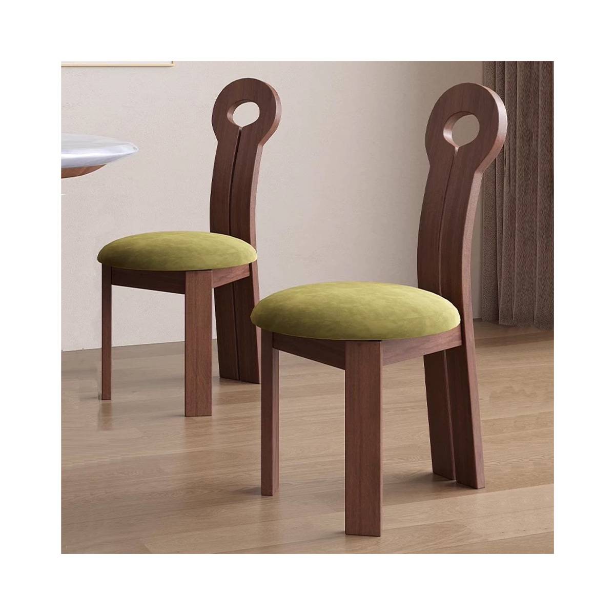 Two walnut wood keyhole chairs with green velvet seats