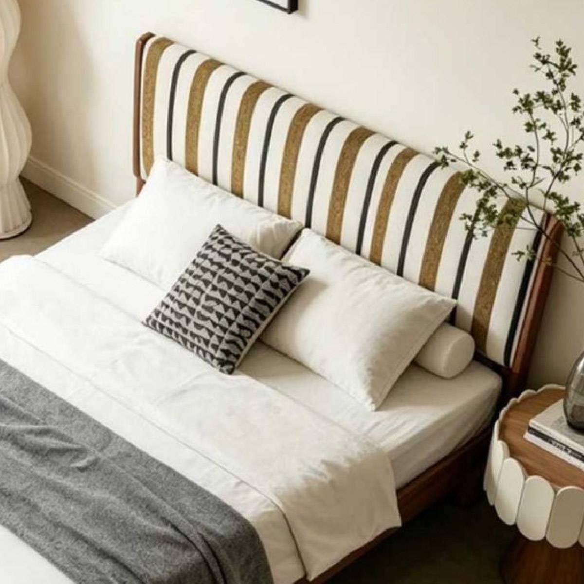 Close-up view of the bed pillows and striped headboard texture