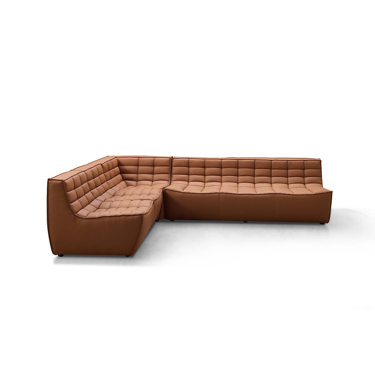 Side view of brown tufted leather sofa