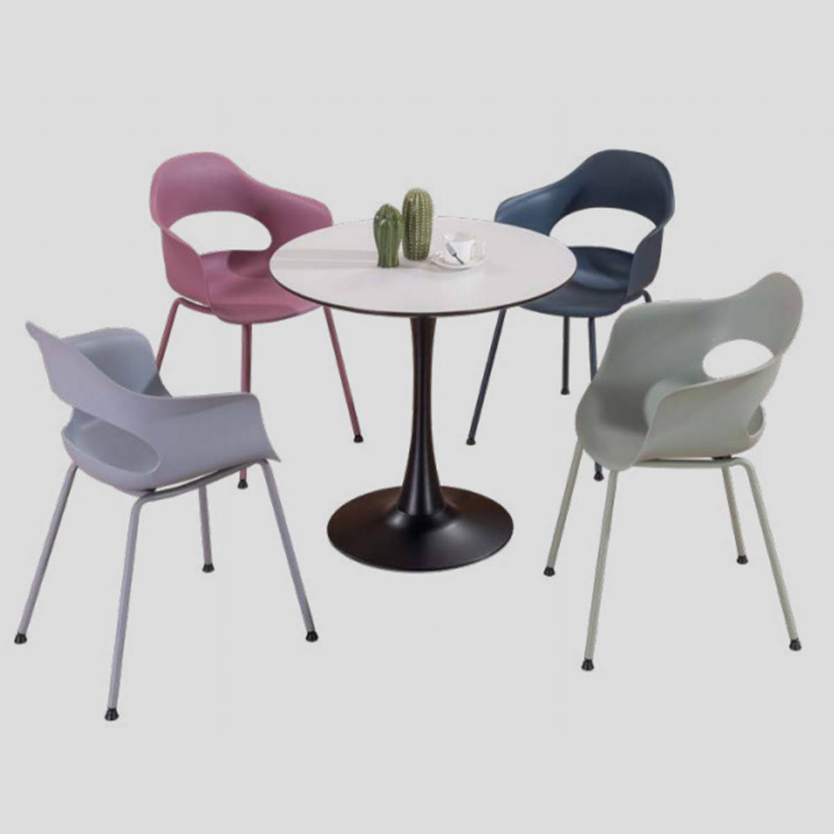 Round table surrounded by four colorful chairs with cactus decoration
