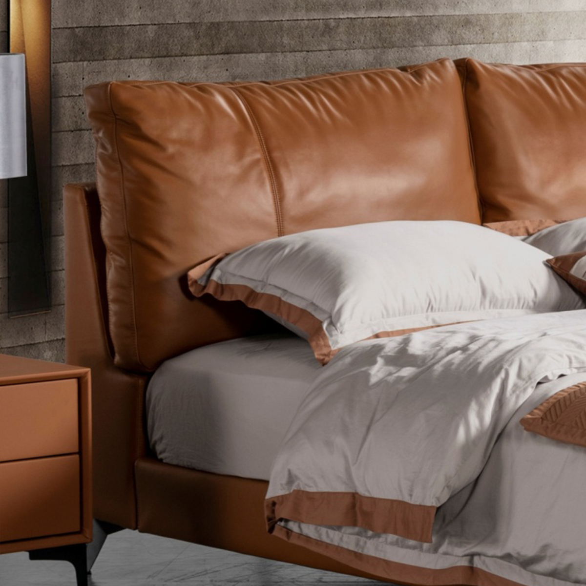 Close-up of the brown leather headboard showing the texture and stitching.