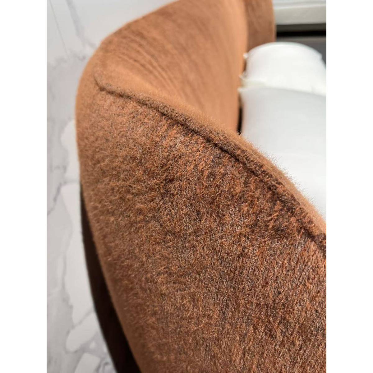 Close-up detail of the brown chenille fabric texture on the bed headboard