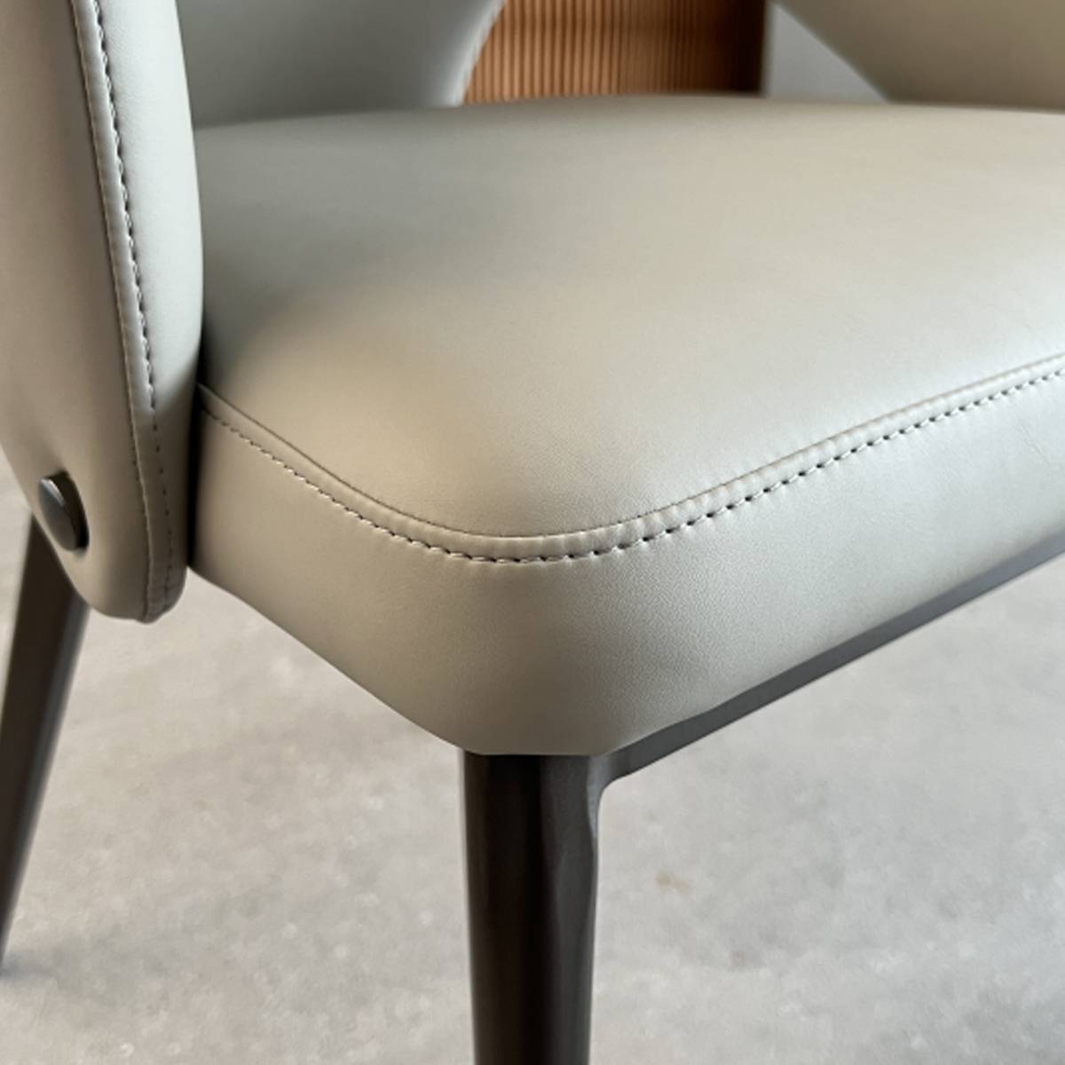 Close-up detail of the beige leather seat corner and stitching