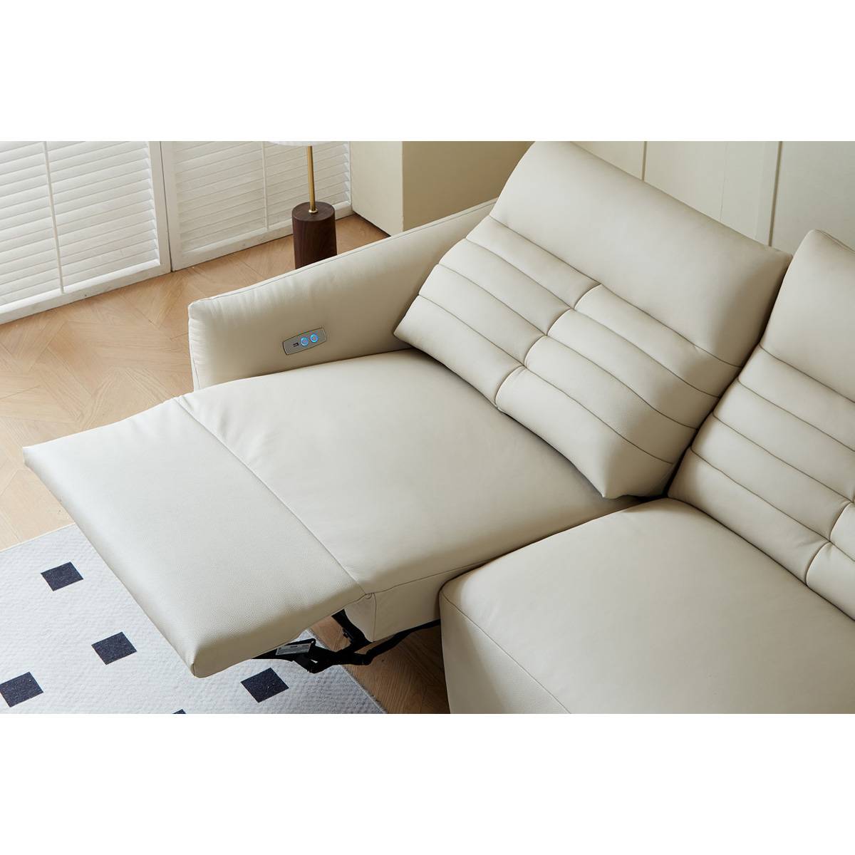 Close-up of the sofa's electric reclining mechanism and control panel on the armrest