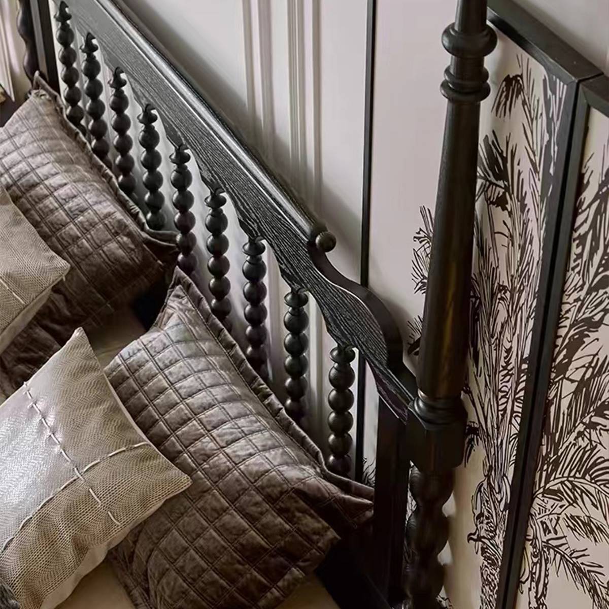 Close-up view of the black spindle headboard and pillows