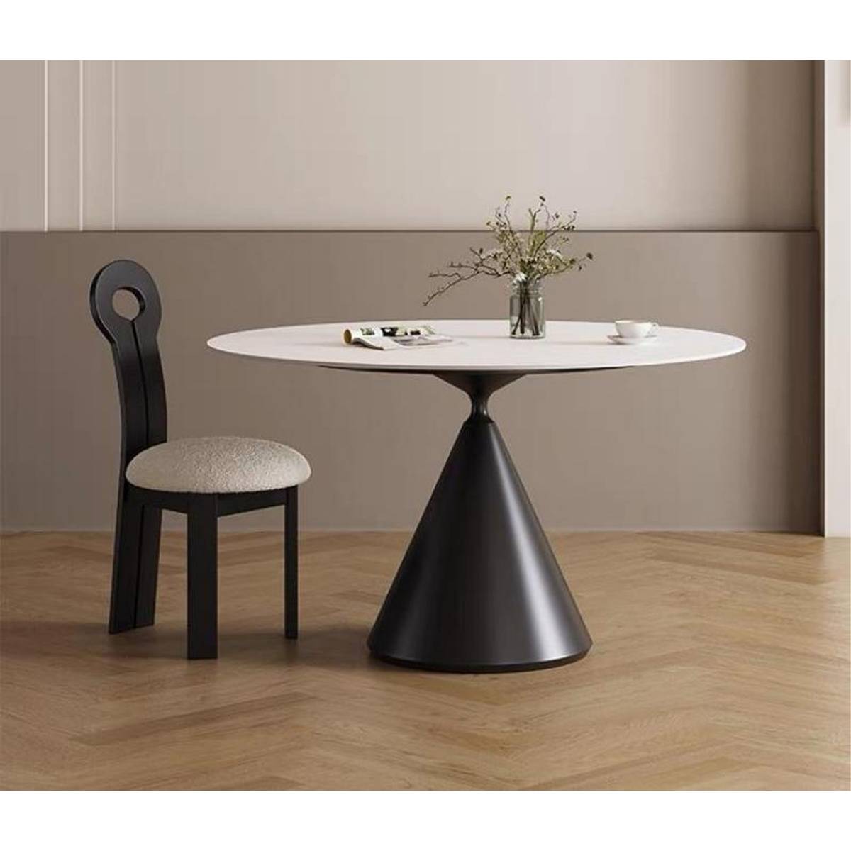 White round dining table with cone base and black chair