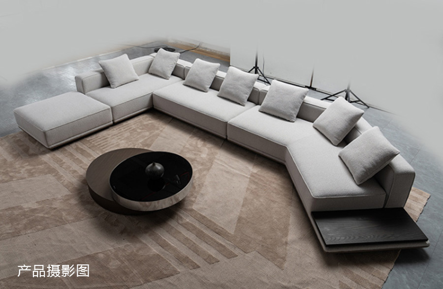 Studio photography of the light grey modular sofa showing the full L-shape configuration and side table.