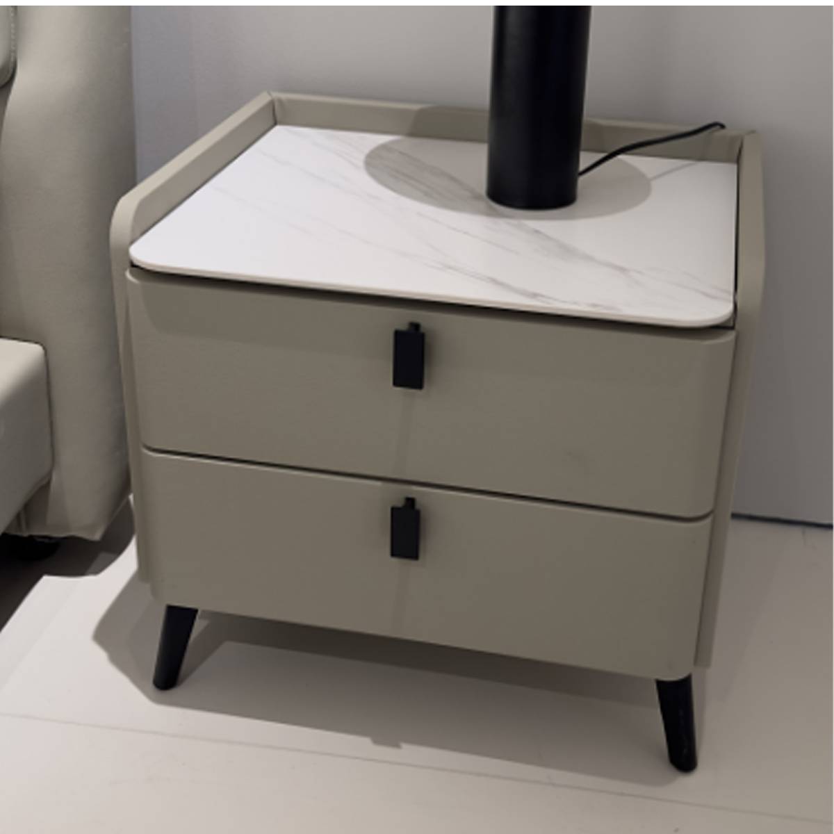Close-up of the bedside table showing the rock slab top and drawer details
