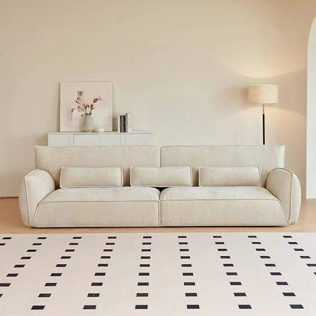 Front view of a beige 4-seater straight fabric sofa in a minimalist living room setting
