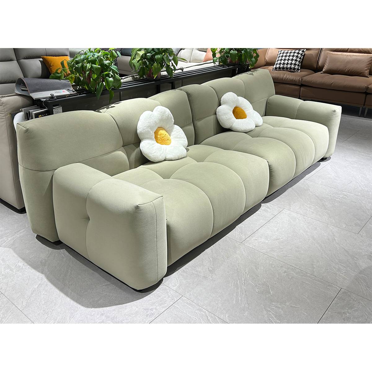 Full view of the light green Puff straight sofa with flower cushions