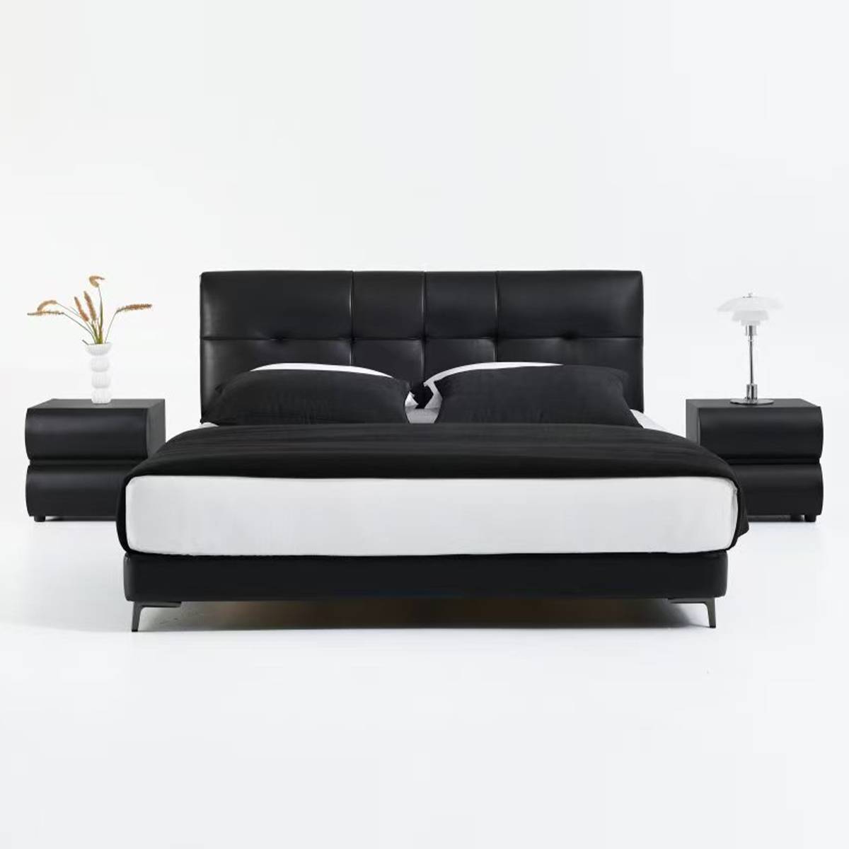 Front view of black leather bed with tufted headboard