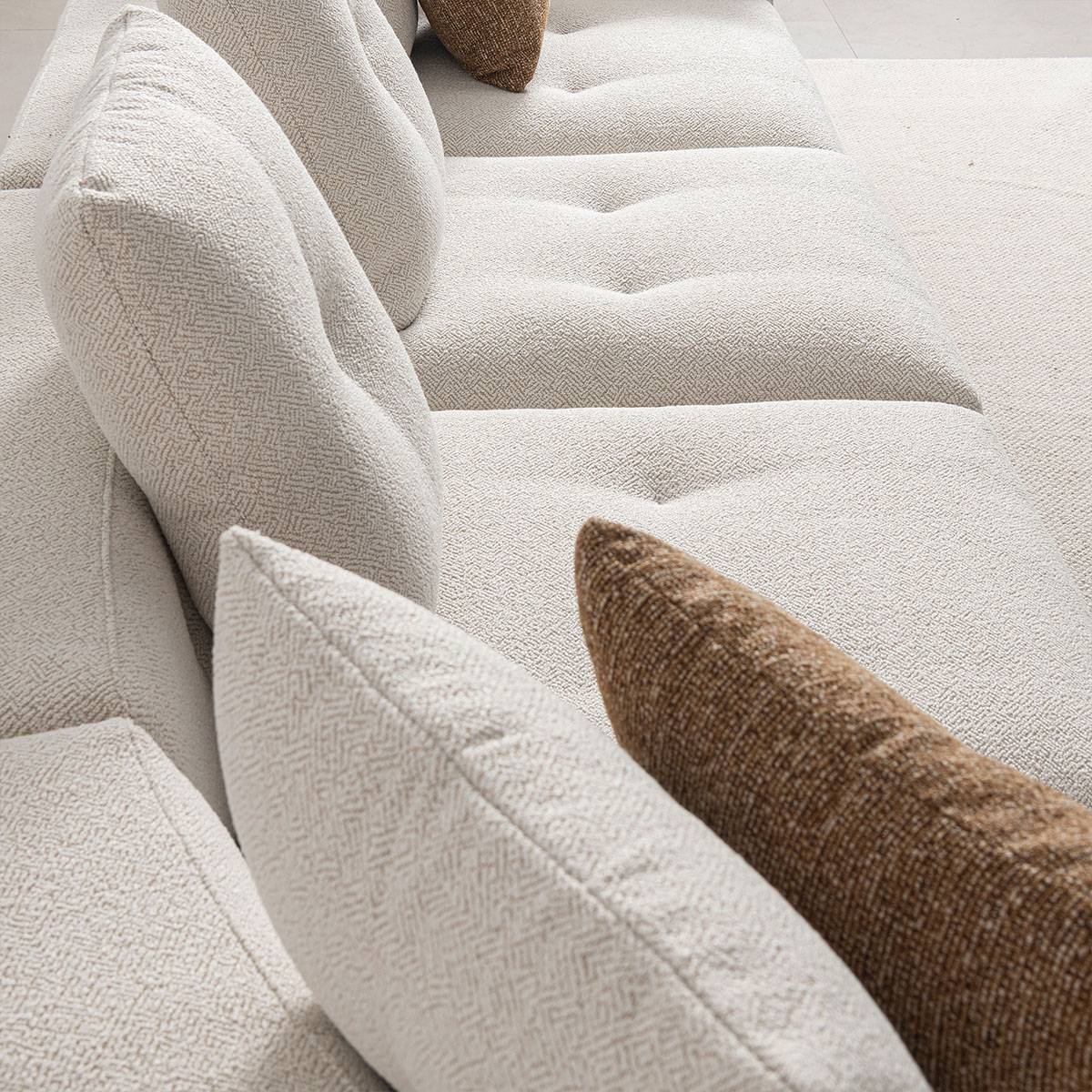 Close-up of beige textured fabric sofa cushions