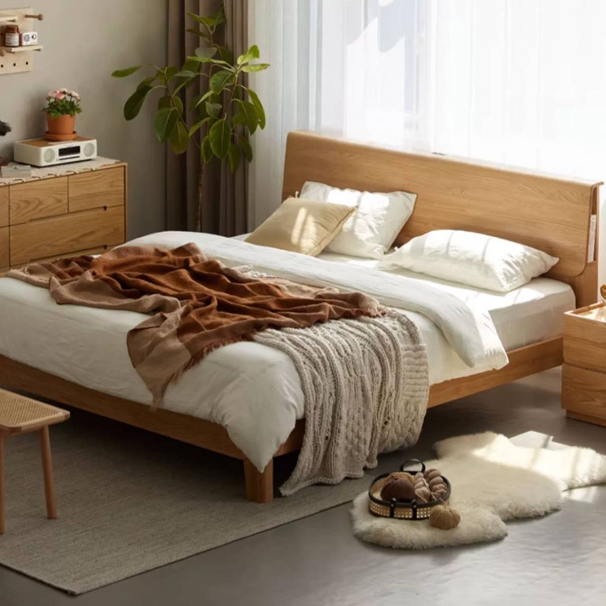 Bed styled with white bedding and a brown throw blanket