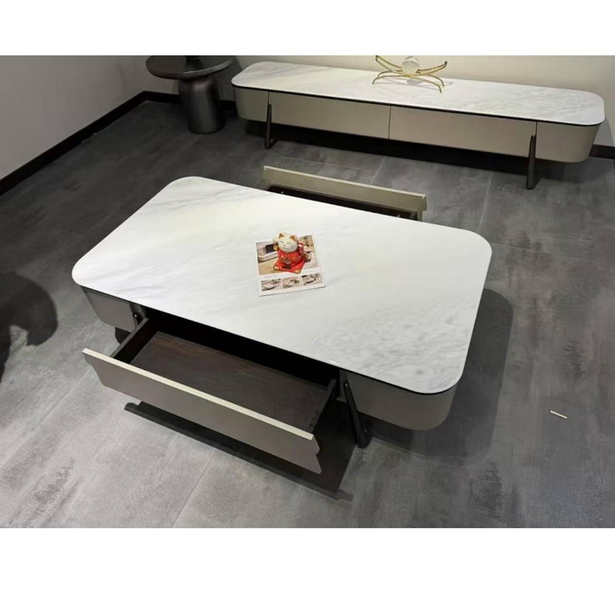 High-angle view of the coffee table showing an open drawer and a matching TV console in the background.