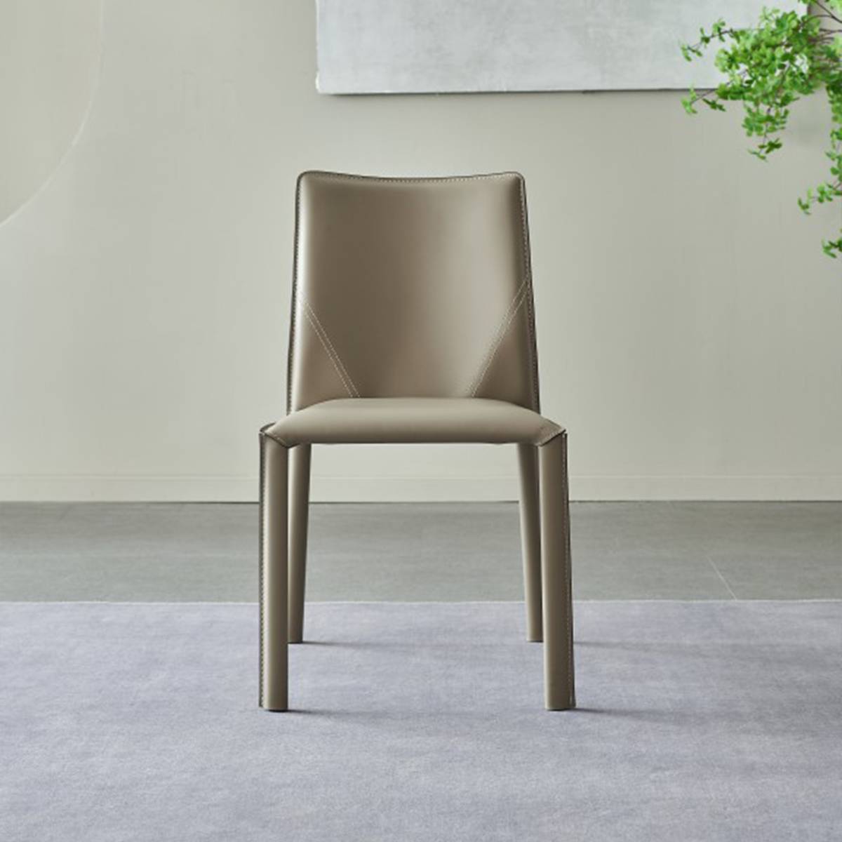 Front view of a grey leather dining chair with minimalist design