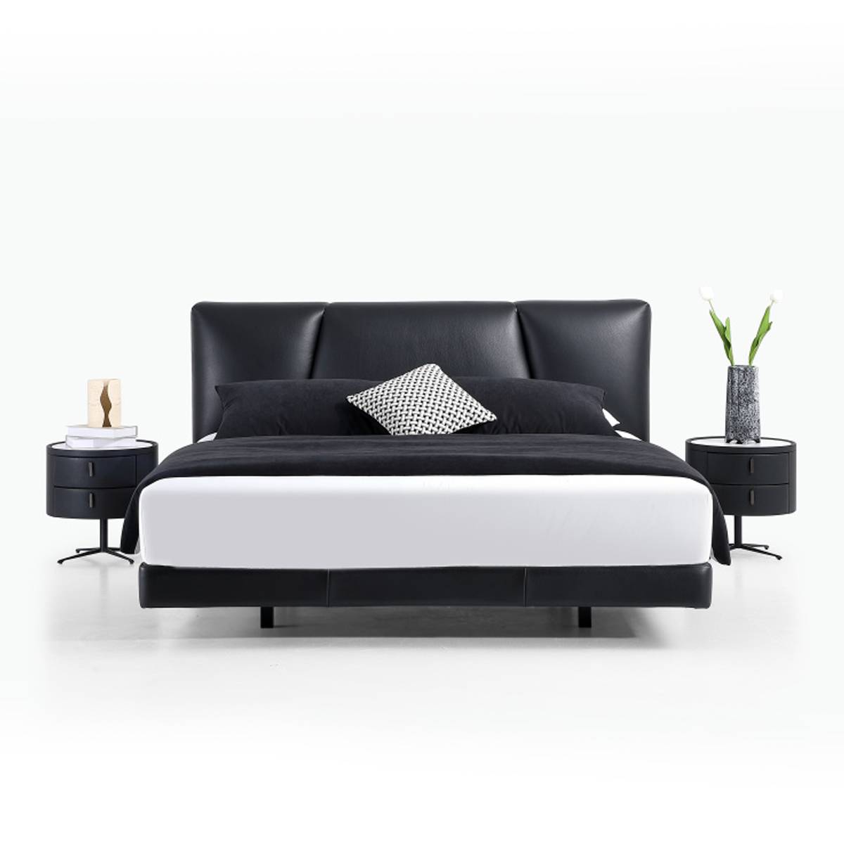 Front view of the black leather bed showing the headboard and frame
