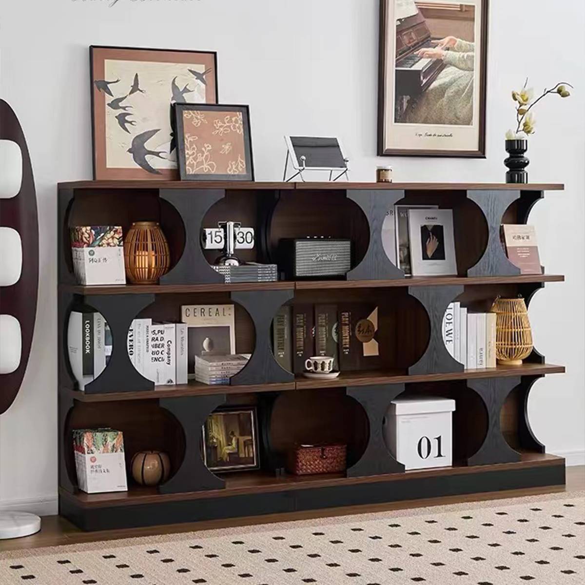 Bookcase styled with various books, a radio, and decorative items