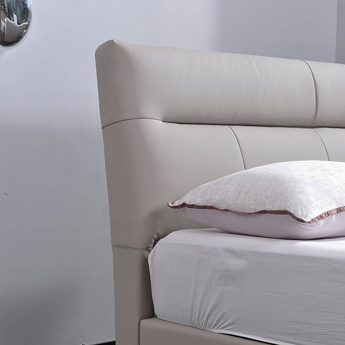 Full view of the grey leather bed in a modern bedroom setting