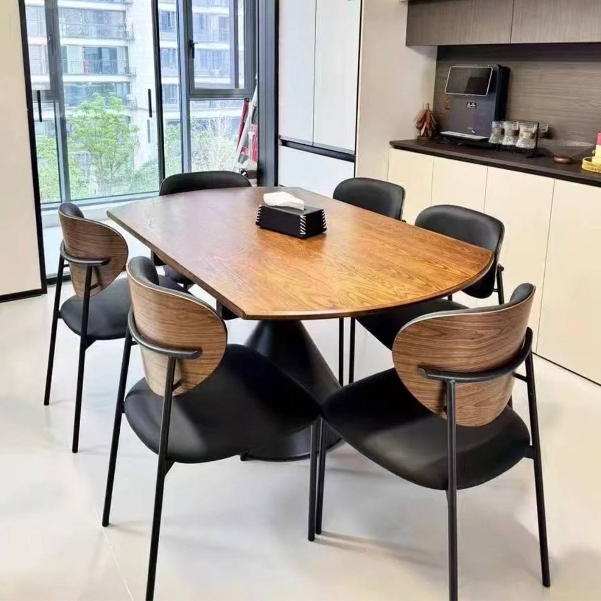 Side view of the dining table showing the wood grain texture and chair arrangement