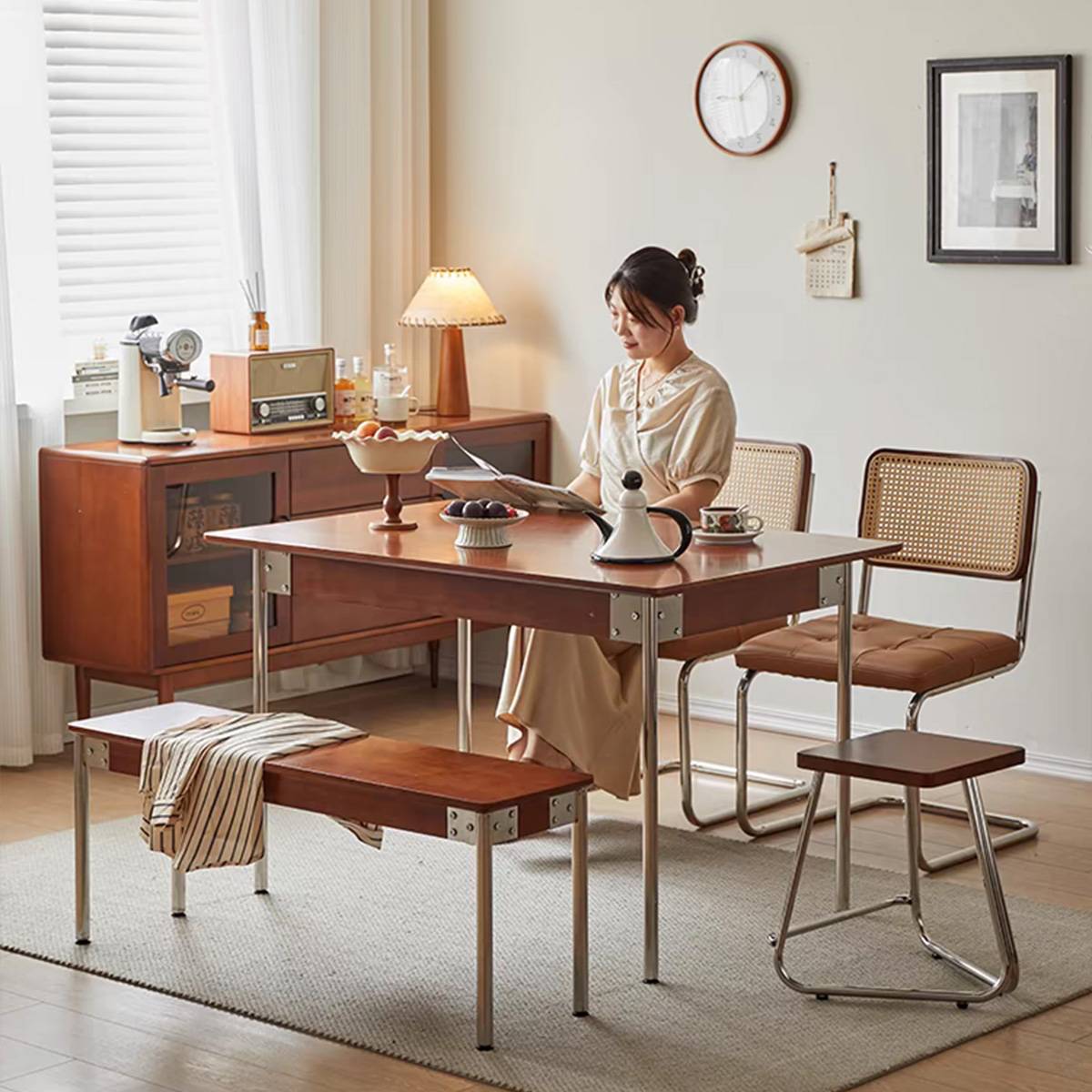 Woman reading at the dining table, showing the table's use in a home setting