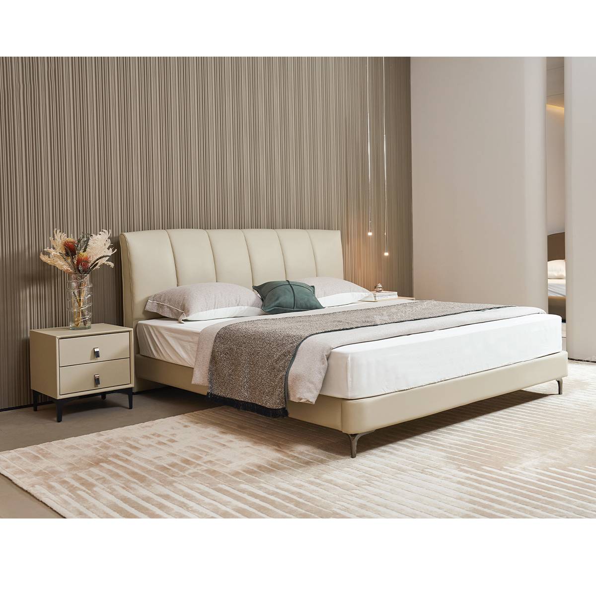 Side view of the beige leather bed with matching bedside table