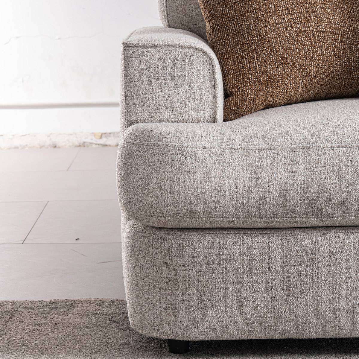 Close-up detail of the sofa armrest and fabric texture