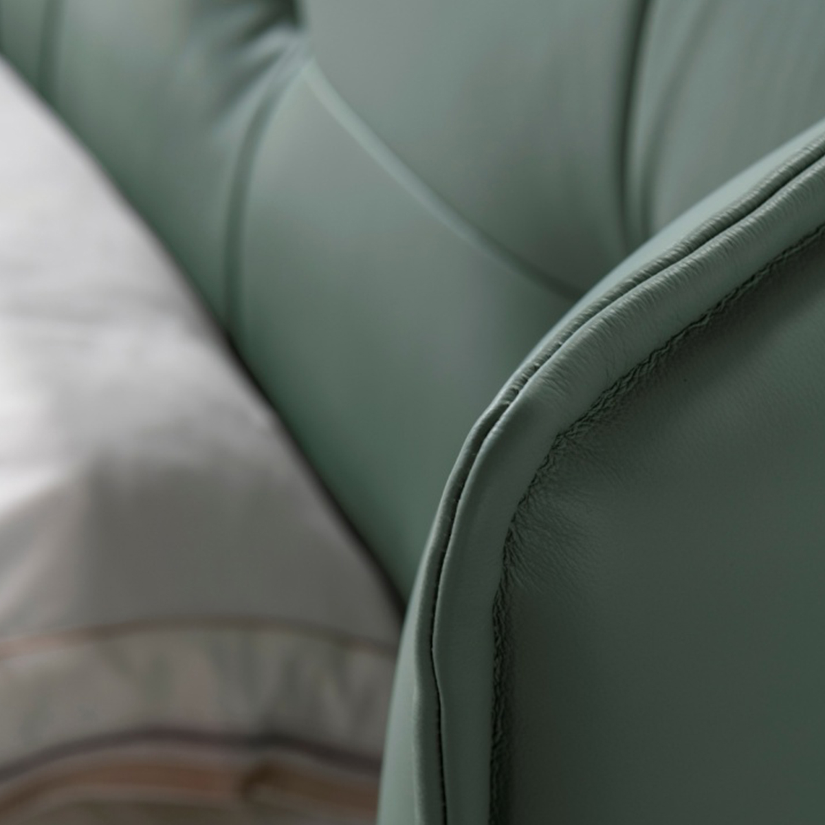 Close-up detail of the leather stitching and texture on the headboard