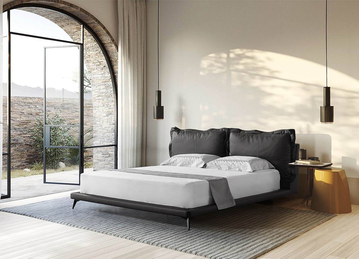 Full view of the black leather bed in a modern bedroom setting