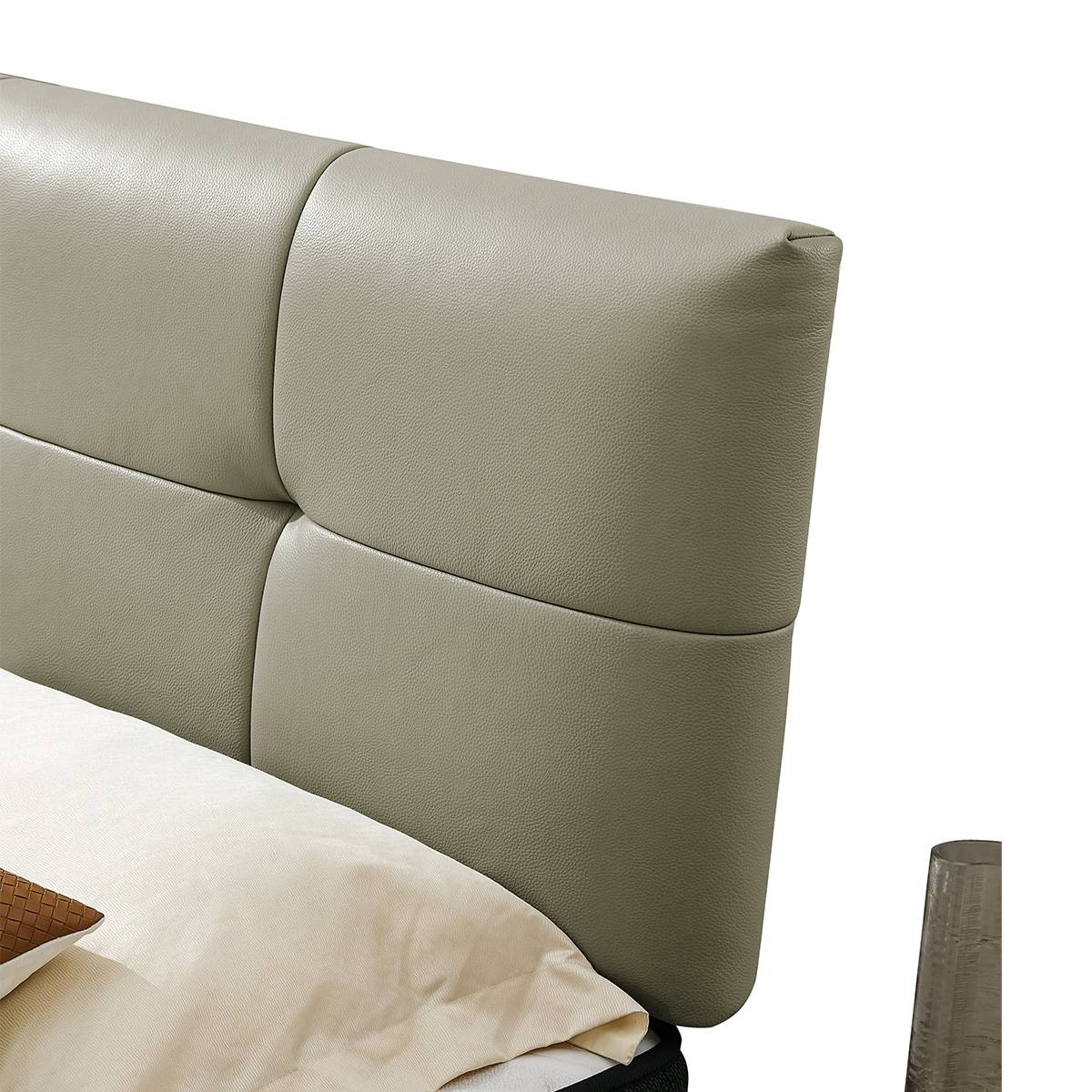 Close-up detail of the top-grain leather texture on the padded headboard.