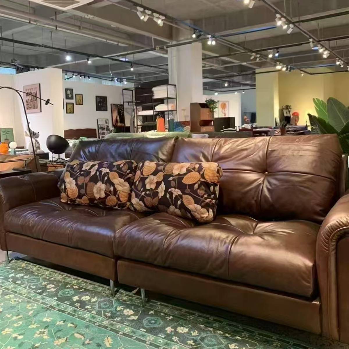 Close-up angle of the sofa showing the leather texture and cushions