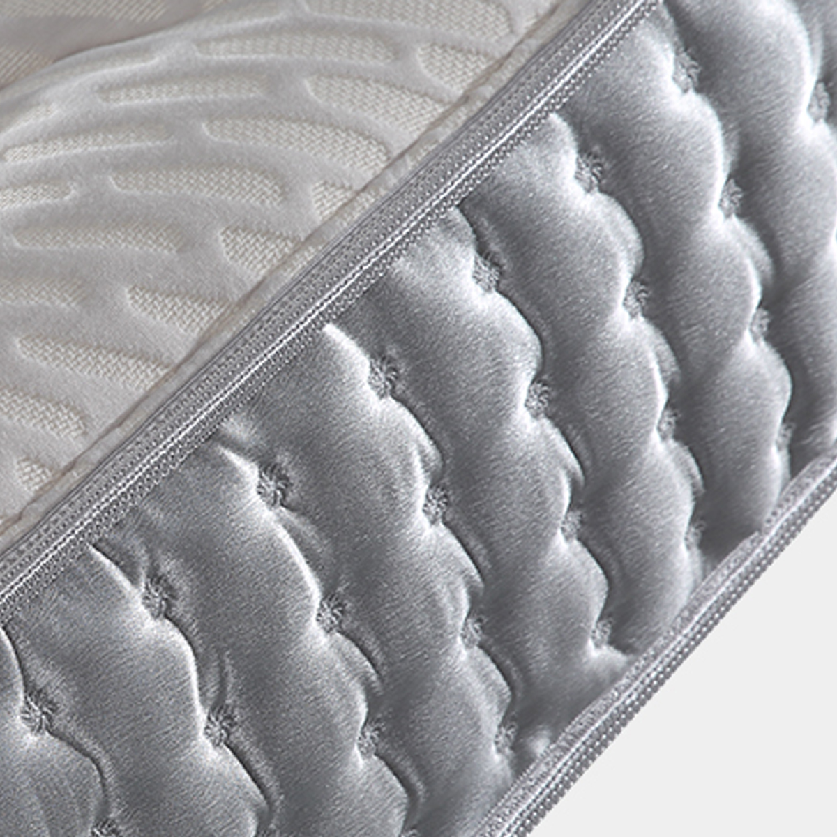 Close-up detail of the mattress side fabric texture and stitching