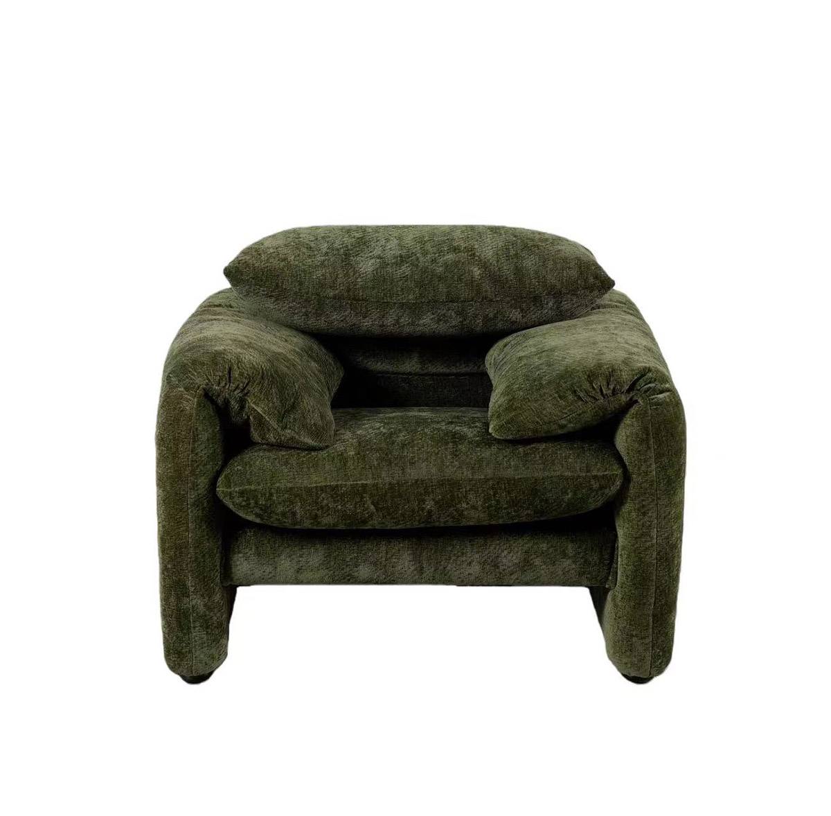Front view of the green velvet lounge chair showing the seat and armrests