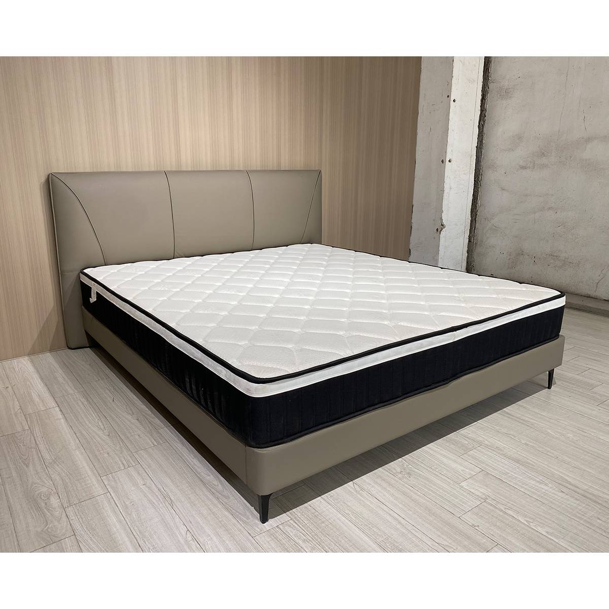 Side angle view of the bed in a room setting with wood flooring