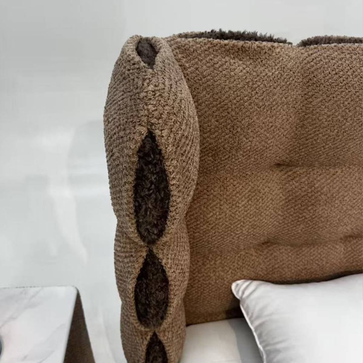 Close-up of the brown chenille headboard showing the unique cutout design and fabric texture.