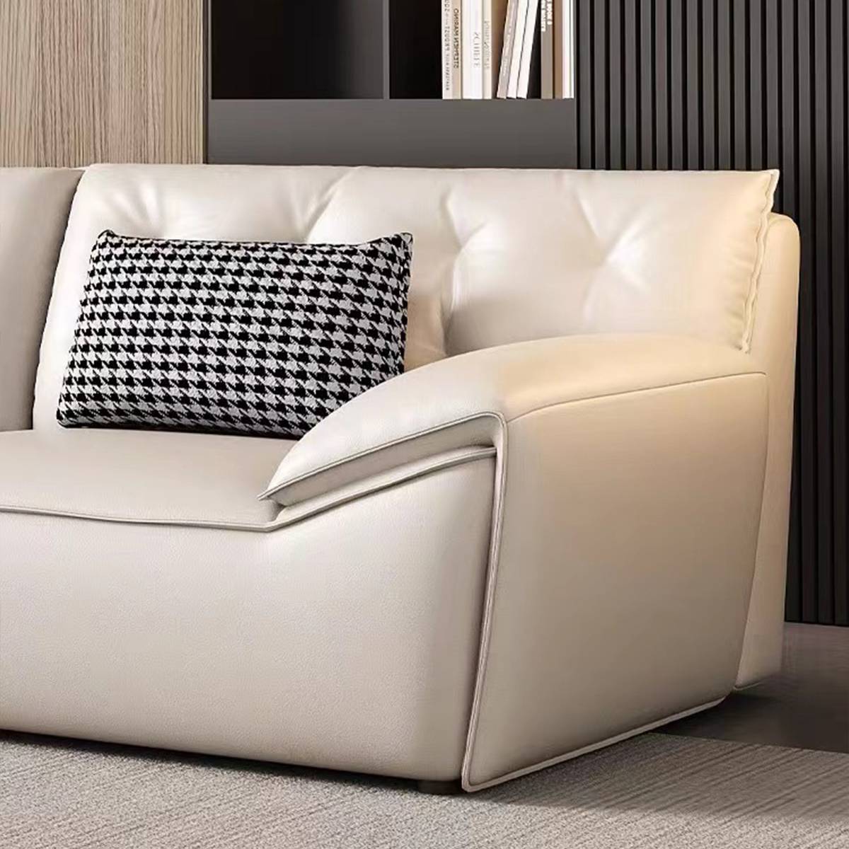 Close-up detail of the sofa armrest and houndstooth cushion