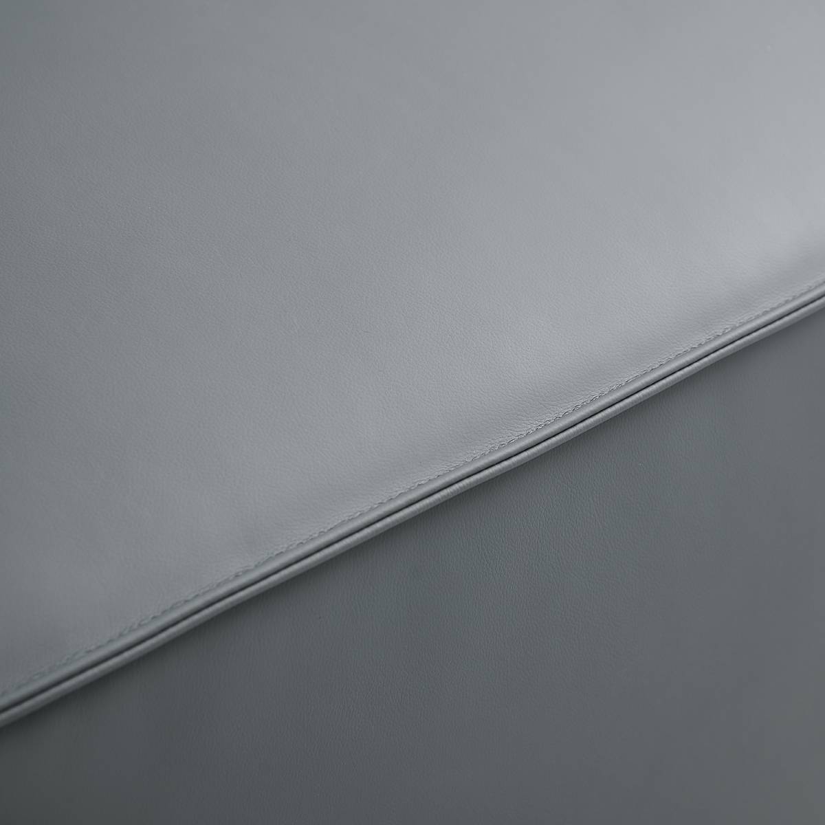 Close-up detail of the grey matte fabric texture and stitching
