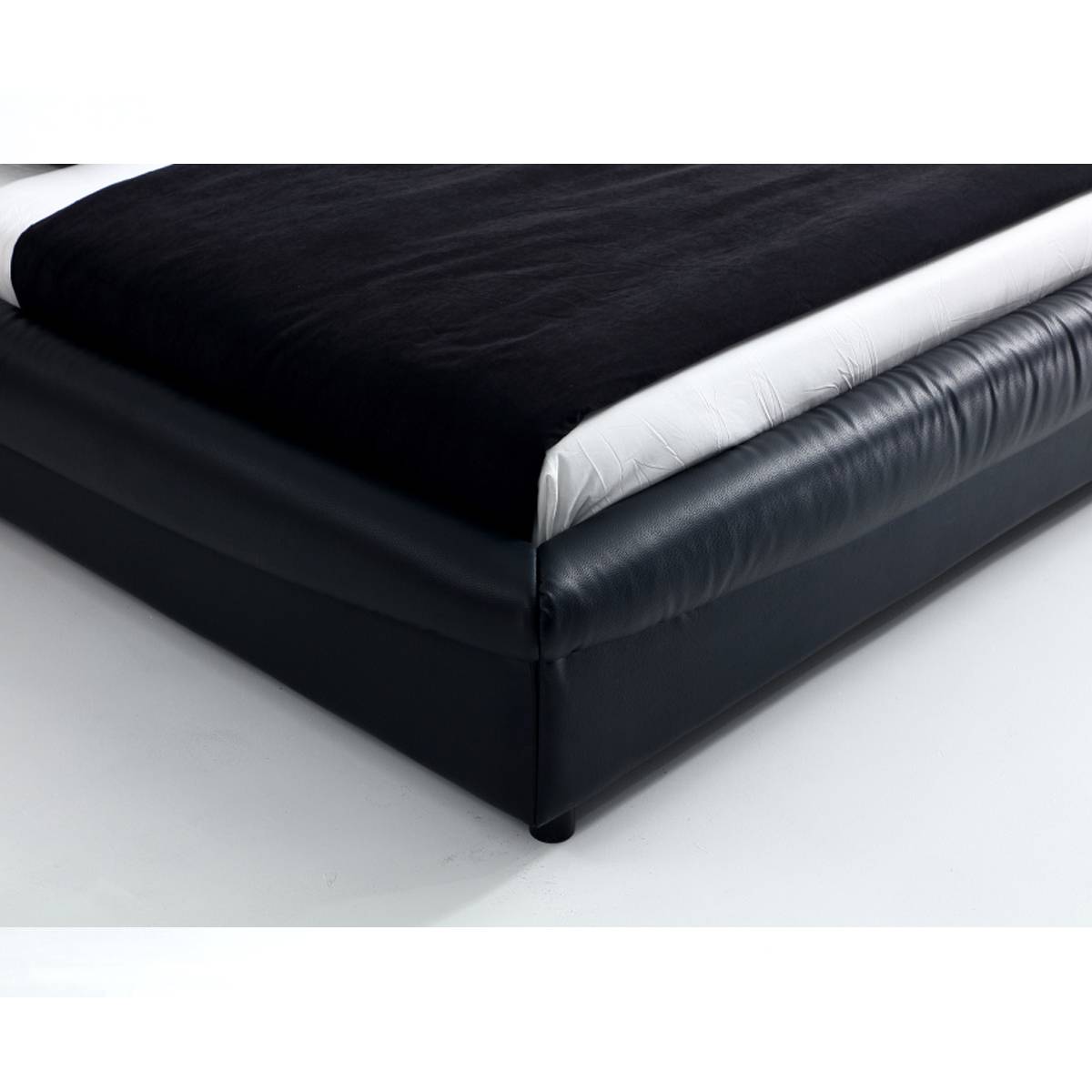 Close-up of the black leather bed frame corner and base