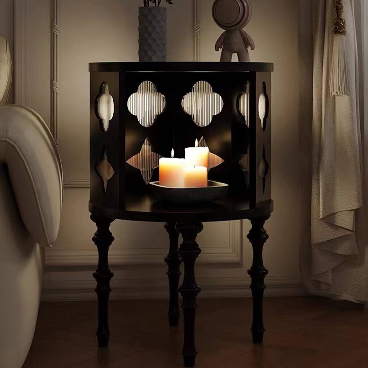 Side table illuminated by candles in a dim setting