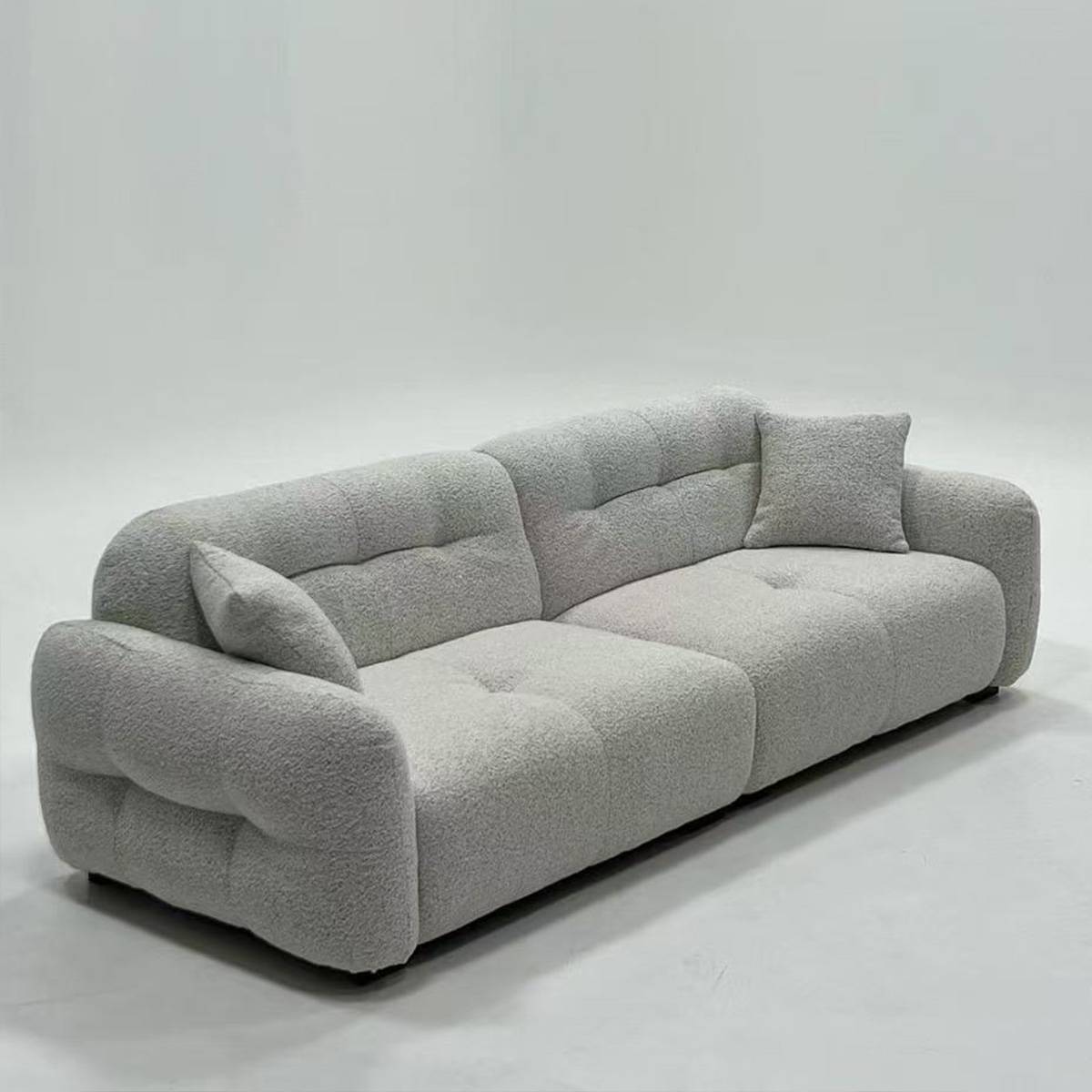 Three-quarter view of the sofa with throw pillows
