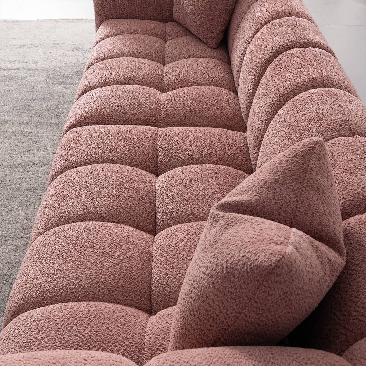 Side view showing the deep tufted seat cushions and backrest