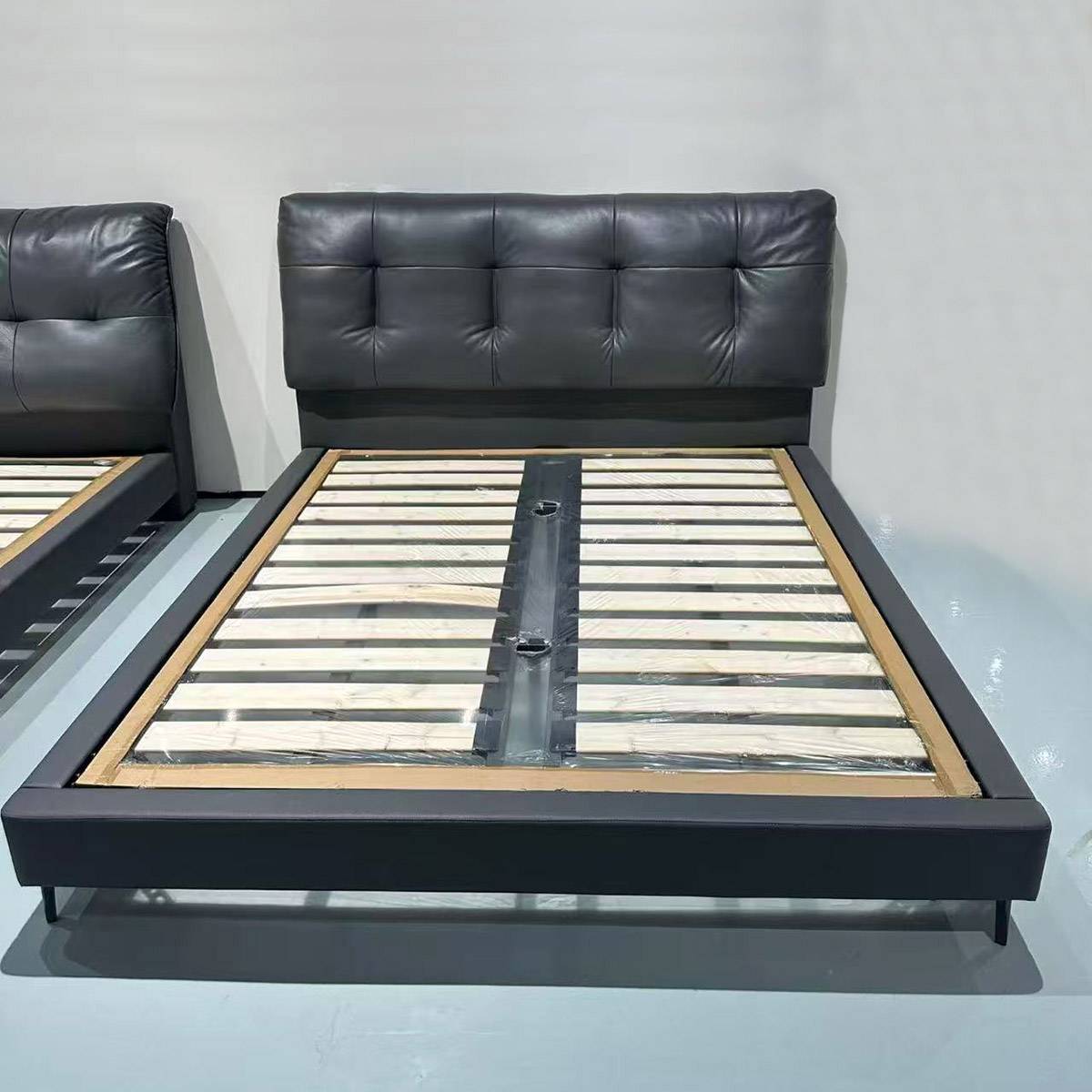 Front view of the bed frame showing the steel and wood slat support system